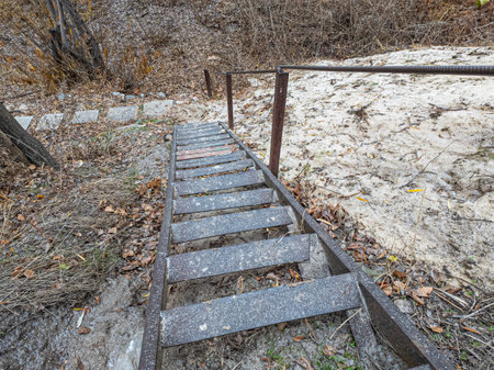 old iron stairs. rusty metal stairs. dangerous steep vintage stairs. descent from the mountain.の写真素材