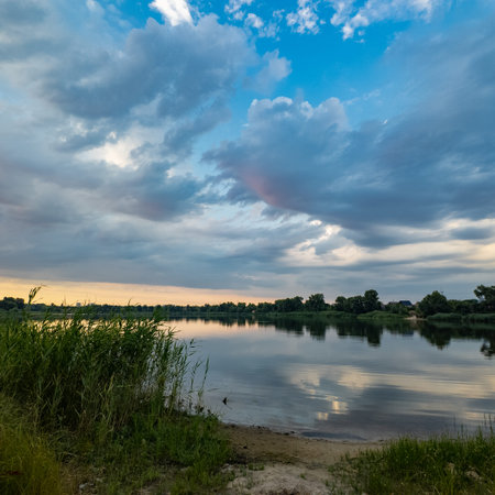 very beautiful sunset with water. summer evening landscape with reflection of clouds in water....