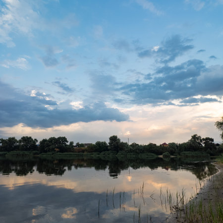 very beautiful sunset with water. summer evening landscape with reflection of clouds in water....