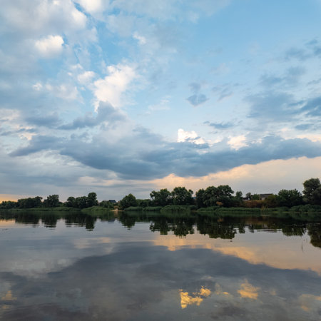 very beautiful sunset with water. summer evening landscape with reflection of clouds in water....