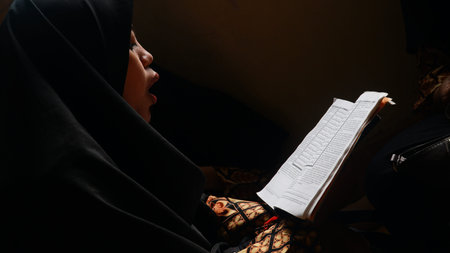Yogyakarta, INDONESIA - January 22, 2020 - Muslim Woman Reading The Quran