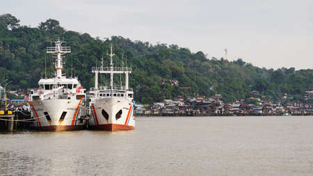 Samarinda, INDONESIA. October 28, 2018: Two ships docked at Samarinda Harbor, which is located on the Mahakam Riverのeditorial素材