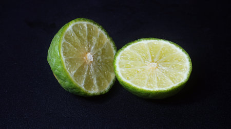Kaffir Lime or Citrus hystrix that has been sliced. Focus selected, black background