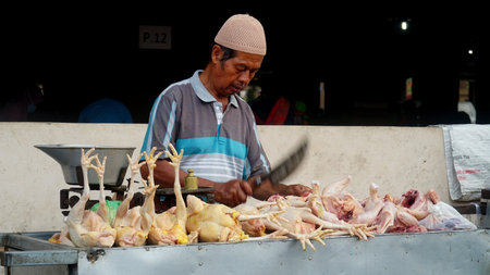 Magelang, Indonesia. March 11, 2021: Man selling chicken meat at Muntilan Market, Magelang