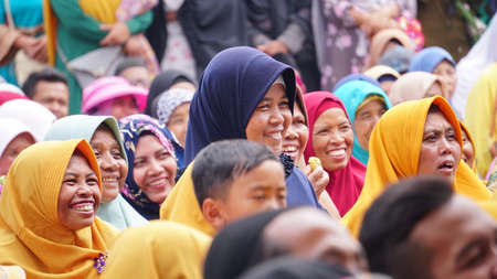 Wonosobo, INDONESIA. October 10, 2019: Muslim women smile and cheer at a religious event. Javanese face. Focus selectedのeditorial素材