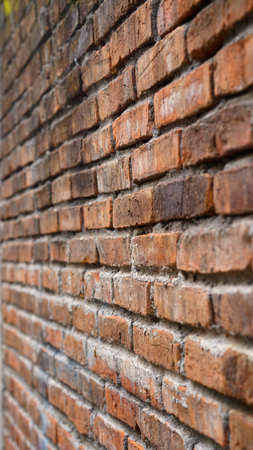 Red brick wall from the side, focus selected, blur on the far side