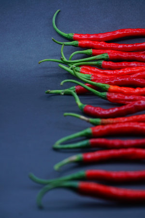 Red chili pepper isolated on a black background, focus selected