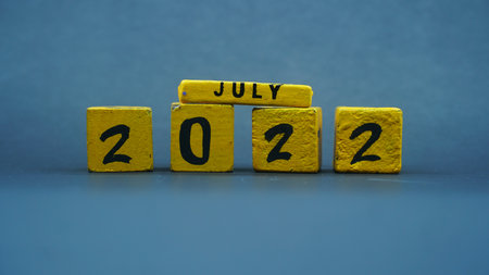 Wooden block calendar for July 2022. Yellow on a dark backgroundの写真素材