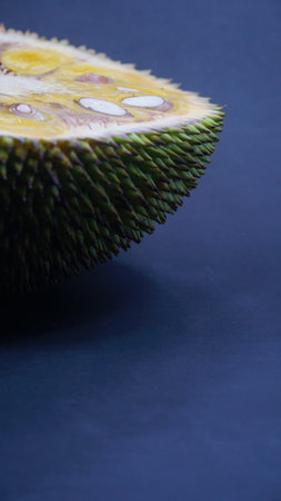 Slice of jackfruit on a dark background. Focus selected