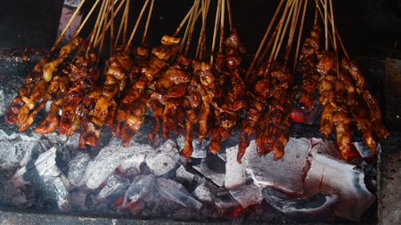 Chicken satay is being grilled over charcoal. Focus selected. Top viewの写真素材