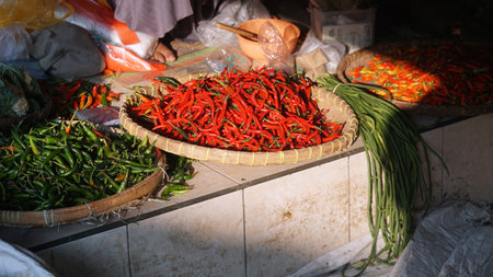Red chili and green chili in a bamboo basket at a traditional market. Focus selectedの写真素材