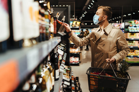 Man shopping in supermarket in mask during quarantine