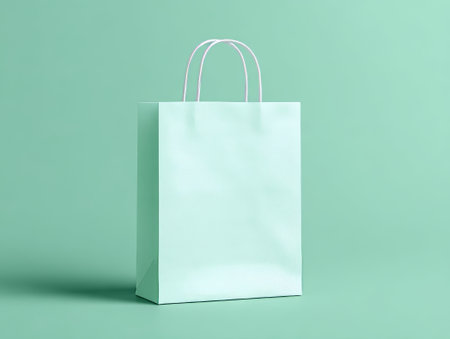 Eco paper bag on bright green backdrop. Modern vibe for sustainability or retail themes, great for green or stylish ideas. Perfect for packaging or nature-inspired visuals.の素材