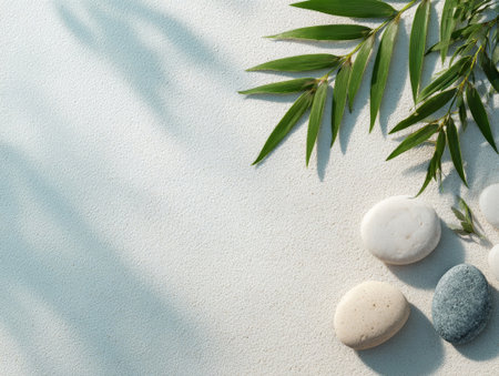 Bamboo leaves with stones on gentle textured base, enhancing zen style. Peaceful composition shows natural elegance and calm.の素材
