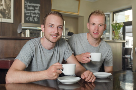 Two male at the coffee break in the cafeの写真素材