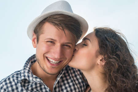 Closeup portrait of a young couple sharing a tender moment while enjoying a day outsideの写真素材