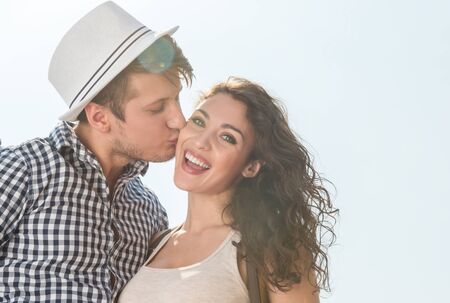 Low angle portrait of a young couple sharing a playful moment while enjoying a sunny day outsideの写真素材