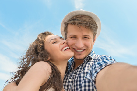 young couple taking a selfie while touring through an cityの写真素材