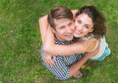 top angle portrait of a young couple on the green grass backgroundの写真素材