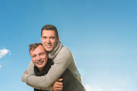 Two young men smiling and holding one another . copyspace
の写真素材