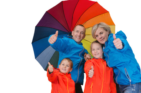 Happy rain family with umbrella show thrumbs up isolated whiteの写真素材