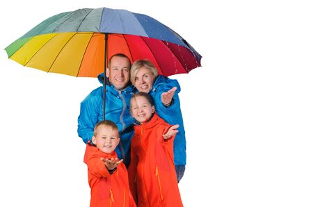Colorful family, mother, father, son and daughter, have fun under rainの写真素材