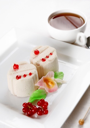 Dessert in white glaze witn berriesの写真素材