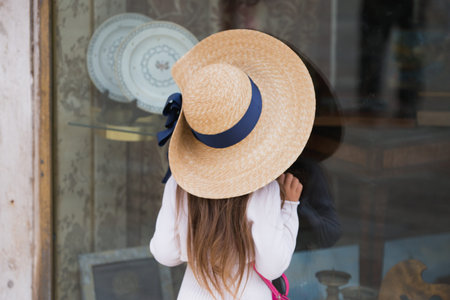 Small girl looking at shop window