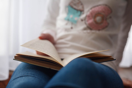 woman reading a book on a white backgroundの写真素材