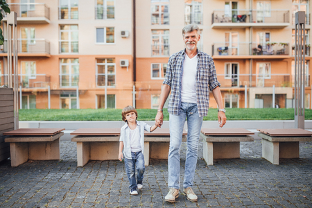 Grandfather with a grandson on a walkの写真素材