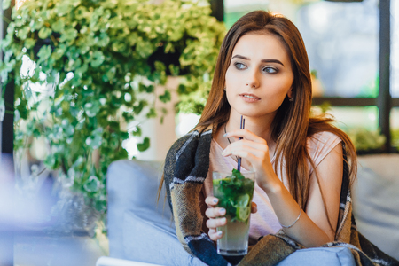 Woman on a summer terrace is drinking cocktailの写真素材
