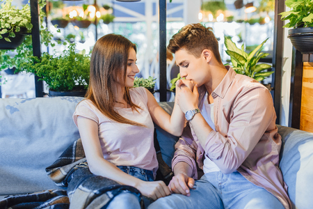The guy and the girl are hugging in the cafe.の写真素材