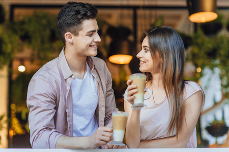 Beautiful couple talking on the terrace of the restaurantの写真素材