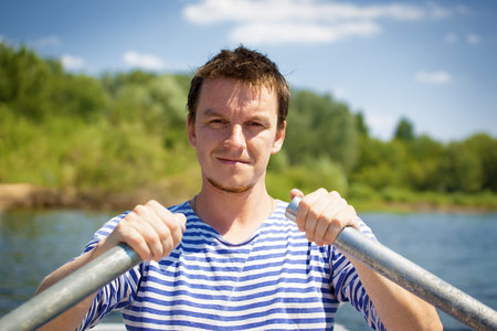 young man rows the boat