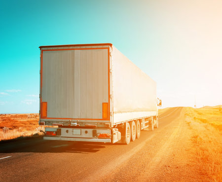 freight truck driving to sunset