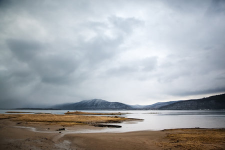 Overcast landscape. River and mountans.