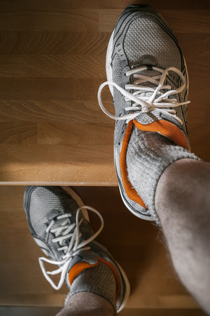 feet in sport shoes on the stairsの写真素材