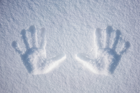Hand print in snowの写真素材