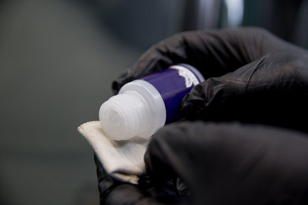 Car detailing - Man applies nano protective coating to the carの写真素材