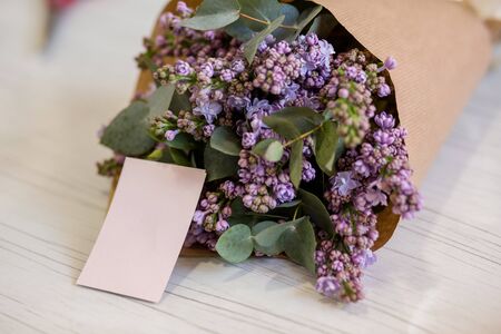 bouquet of flowers with a business card in a flower shopの写真素材