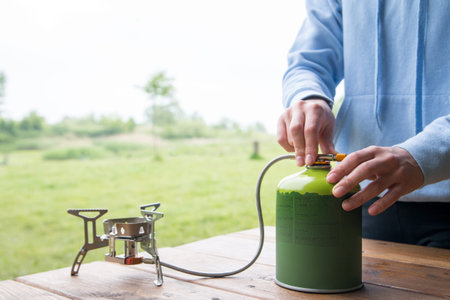 cooking in the campsite with a gas burner and gas cylinderの写真素材