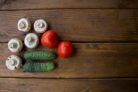 fresh vegetables scallops, tomatoes and mushrooms on the tableの写真素材