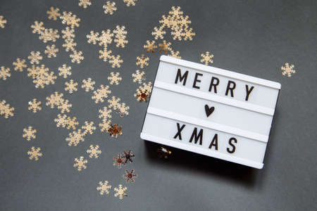 Christmas gray photophone with a sign with the inscription and snowflakesの写真素材