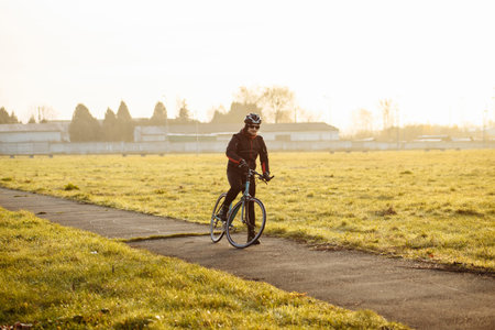 man on a blue bicycle in the morning cold season goes to work