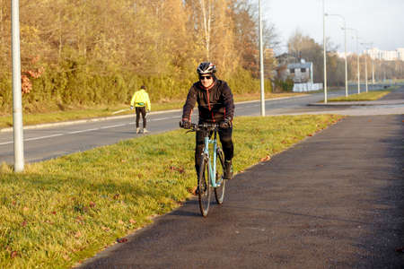 man on a blue bicycle in the morning cold season goes to workの写真素材
