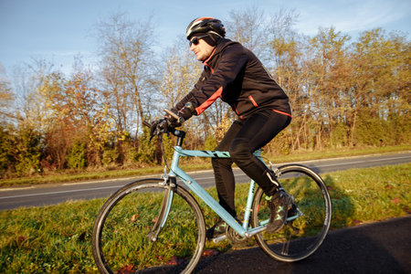 man on a blue bicycle in the morning cold season goes to work
