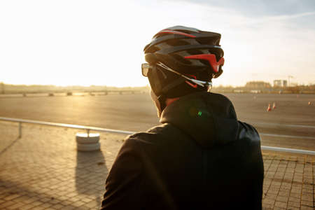 cyclist in black clothes and helmet trains on a bicycleの写真素材