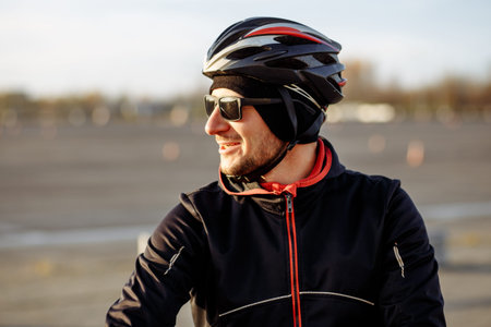 portrait of a cyclist in a black helmet and goggles