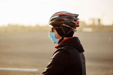 cyclist during quarantine in a helmet and maskの写真素材