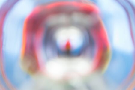 Abstract wavy circles emerging from the center, in blue. Red tonesの写真素材